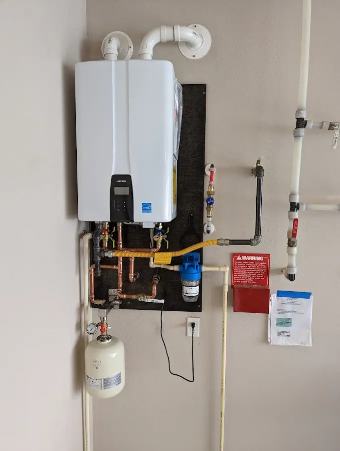 Professional plumber installing copper piping in a Bell Gardens home